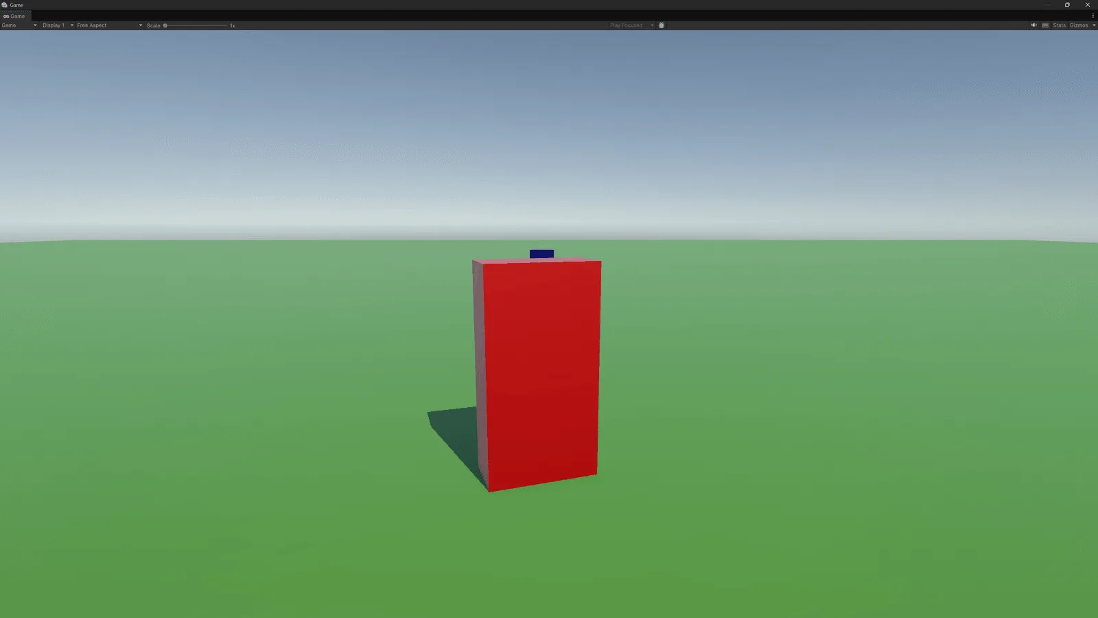 Unity game view of the WeaponsTest prototype showing the player transformed into a tall red robot block on a green firing range